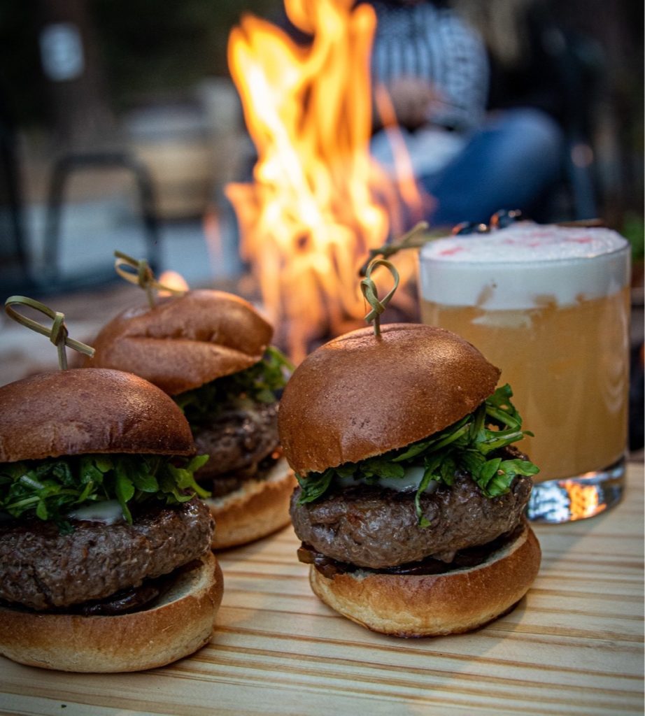 Burgers and a cocktail around the fire pit at Lake Tahoe Cocktail Corner