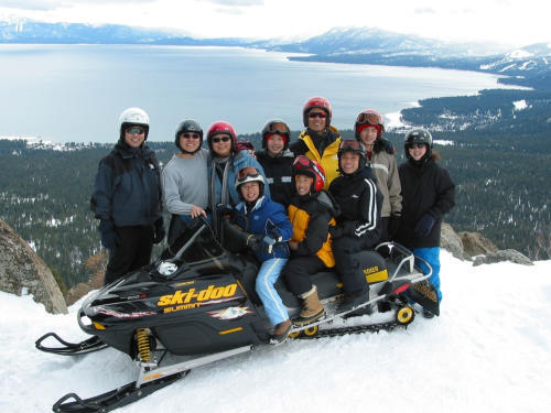 Family in the snow with Lake Tahoe in the background